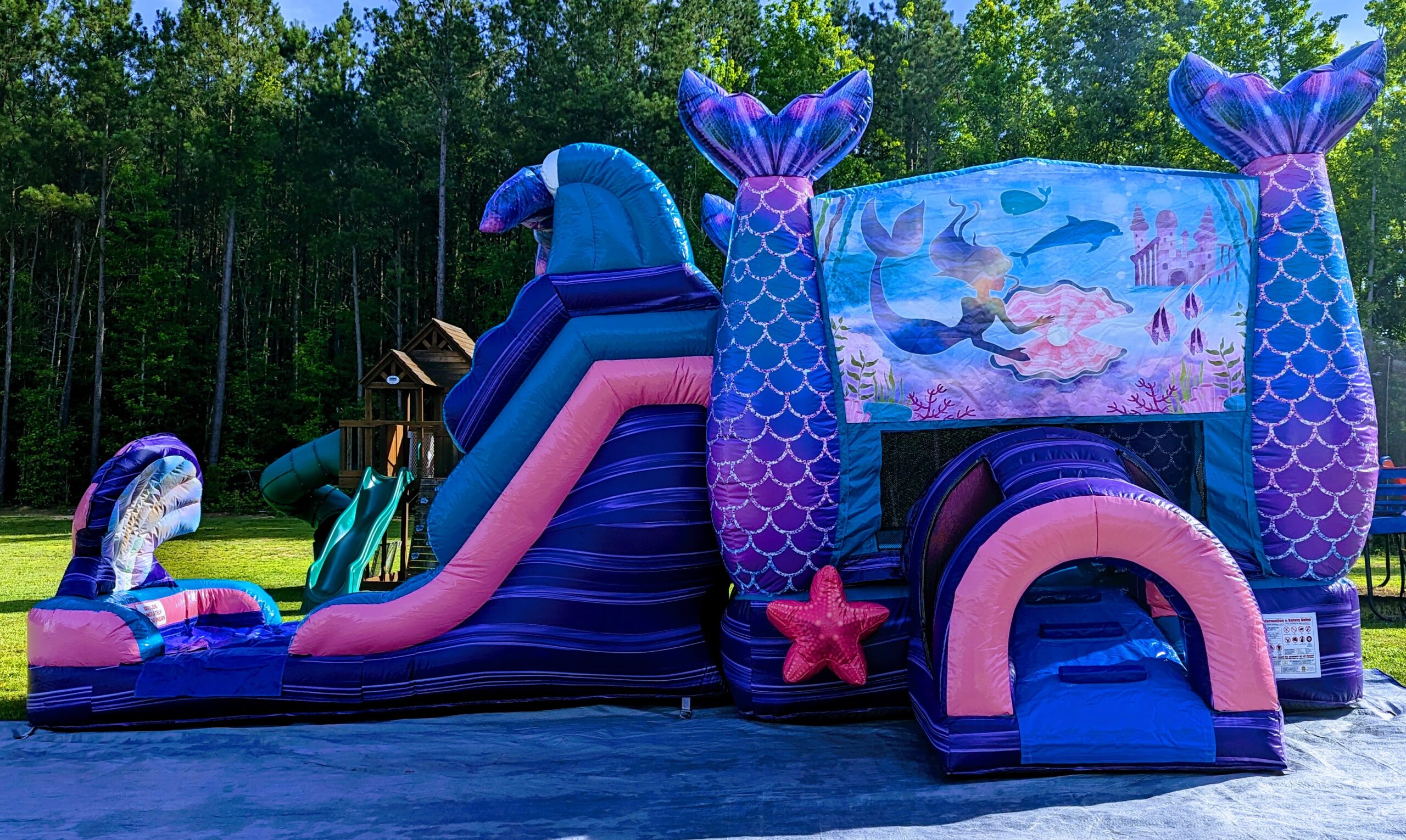 Mermaid bounce house with dual slide rental from Inflatables NC for a kids birthday party