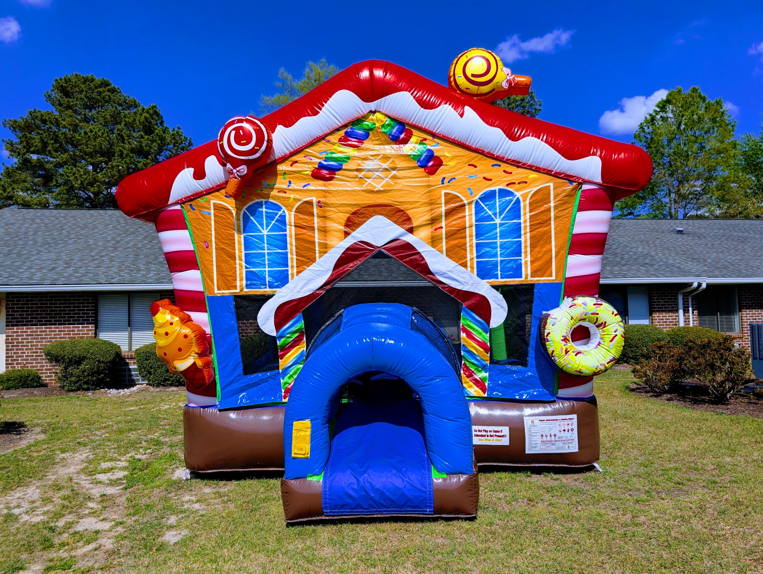 Colorful themed bounce house rental from Inflatables NC set up for a birthday party in Nashville, NC